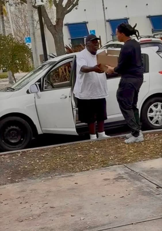 Volunteer delivering a food box to a community member