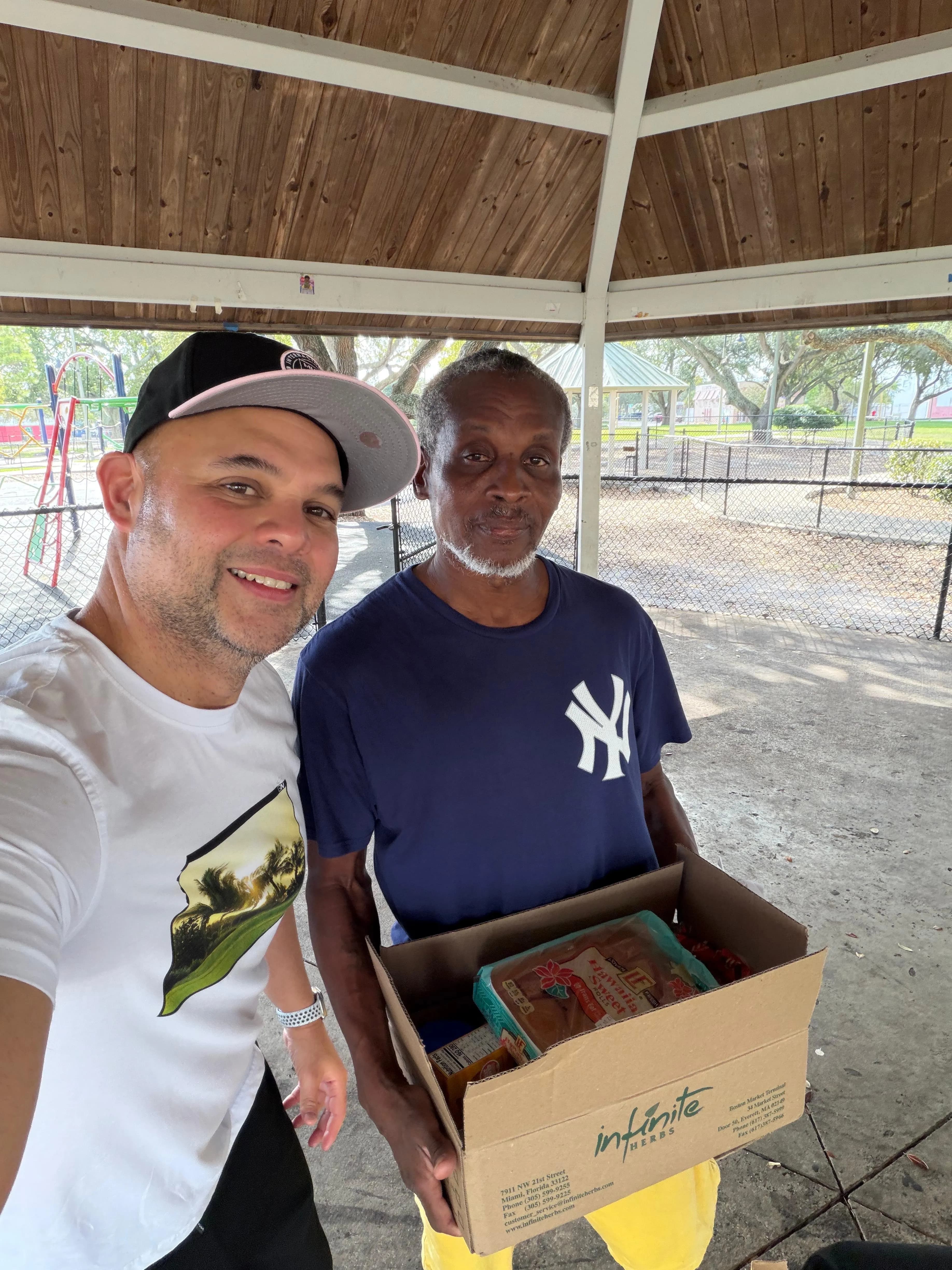 Volunteer handing a food box to a community member